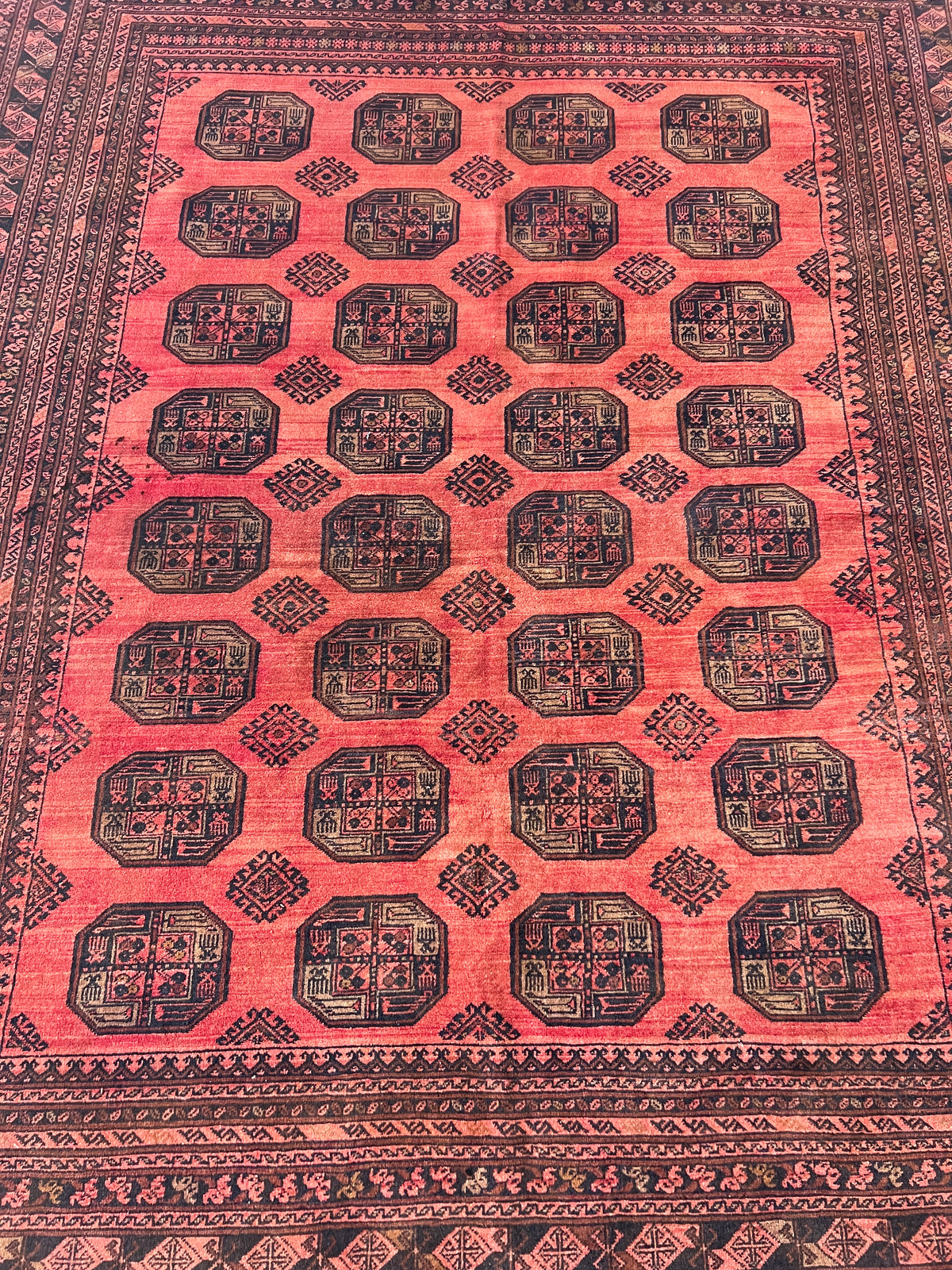 Close-up of a red patterned rug with geometric designs