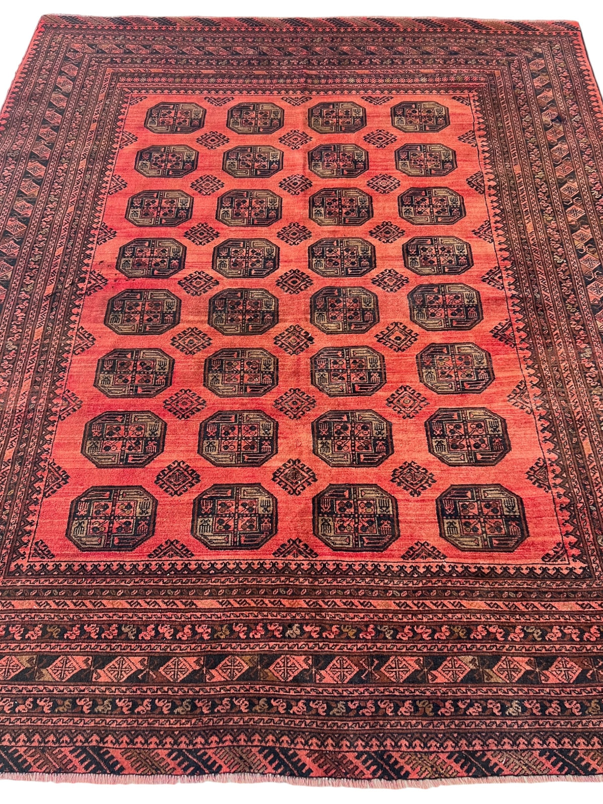 Red and black patterned rug with intricate designs