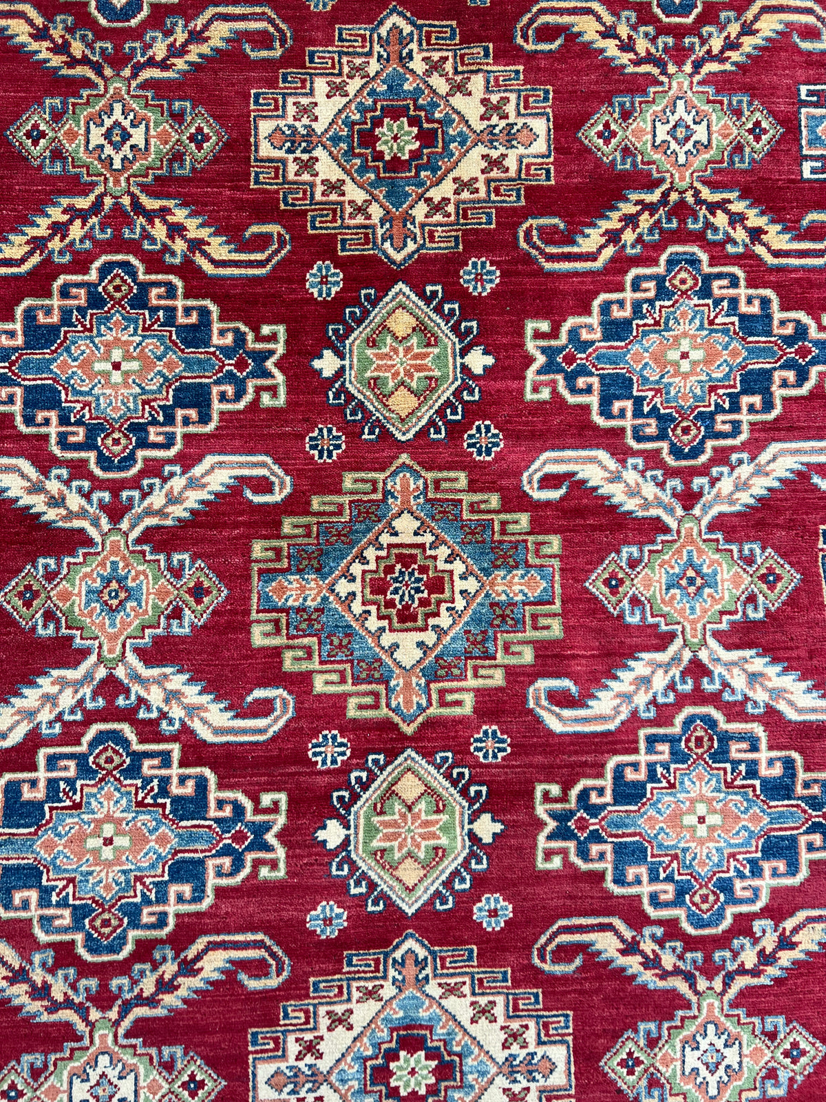 Kazak Rug 9x12 | Red, Ivory & Blue | hand-knotted wool | close-up of pile and border