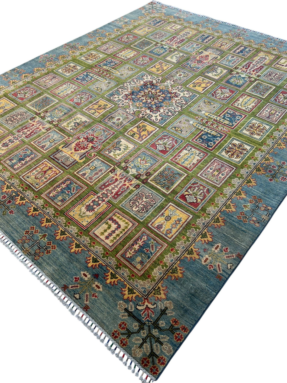 Kazak Garden Rug 8x10 | Green, Light Blue & Gold | hand-knotted wool | angled view