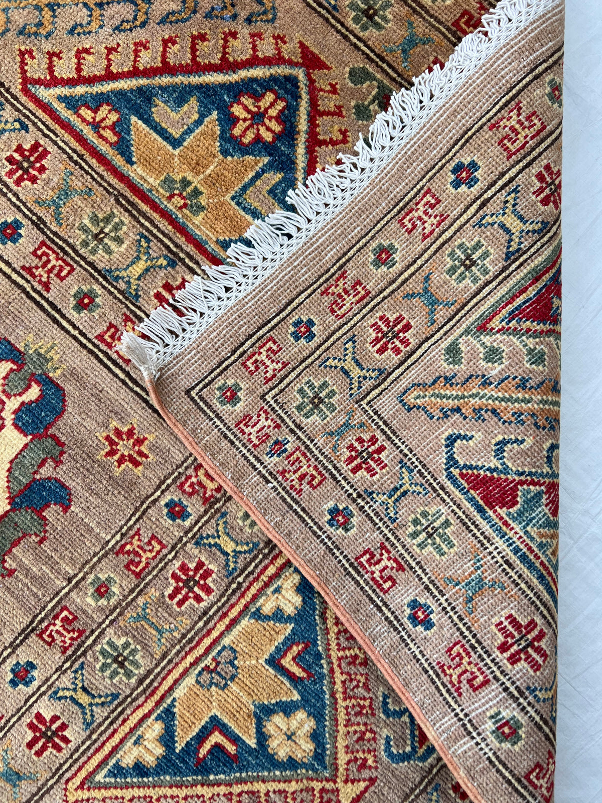 Kazak Rug 9x12 | Taupe, Navy & Red | hand-knotted wool | back of rug, knot detail