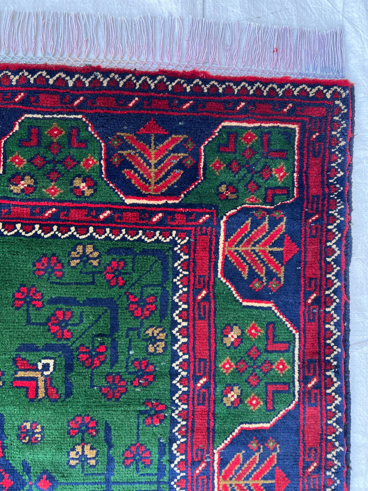 Bukhara Rug 3x5 | Green, Navy & Red | hand-knotted wool | close-up of pile and border