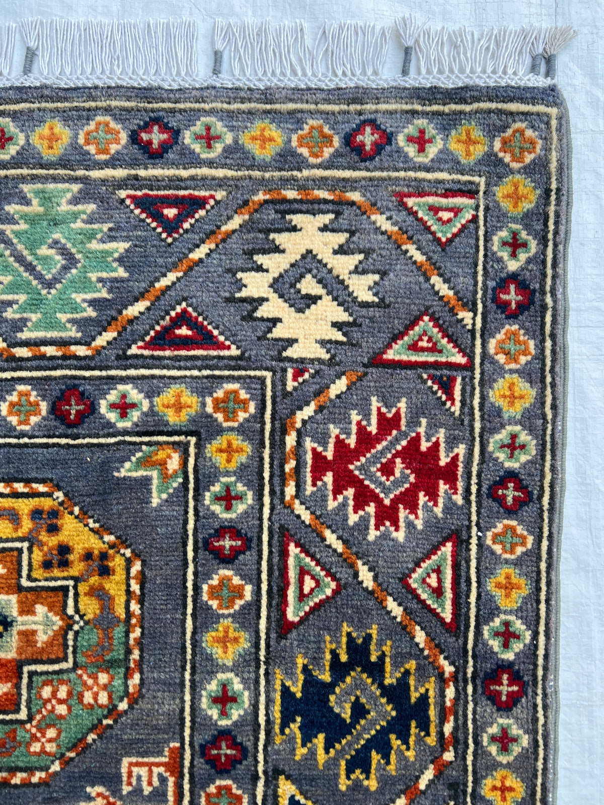 Kazak Rug 3x5 | Charcoal, Red & Gold | hand-knotted wool | close-up of pile and border