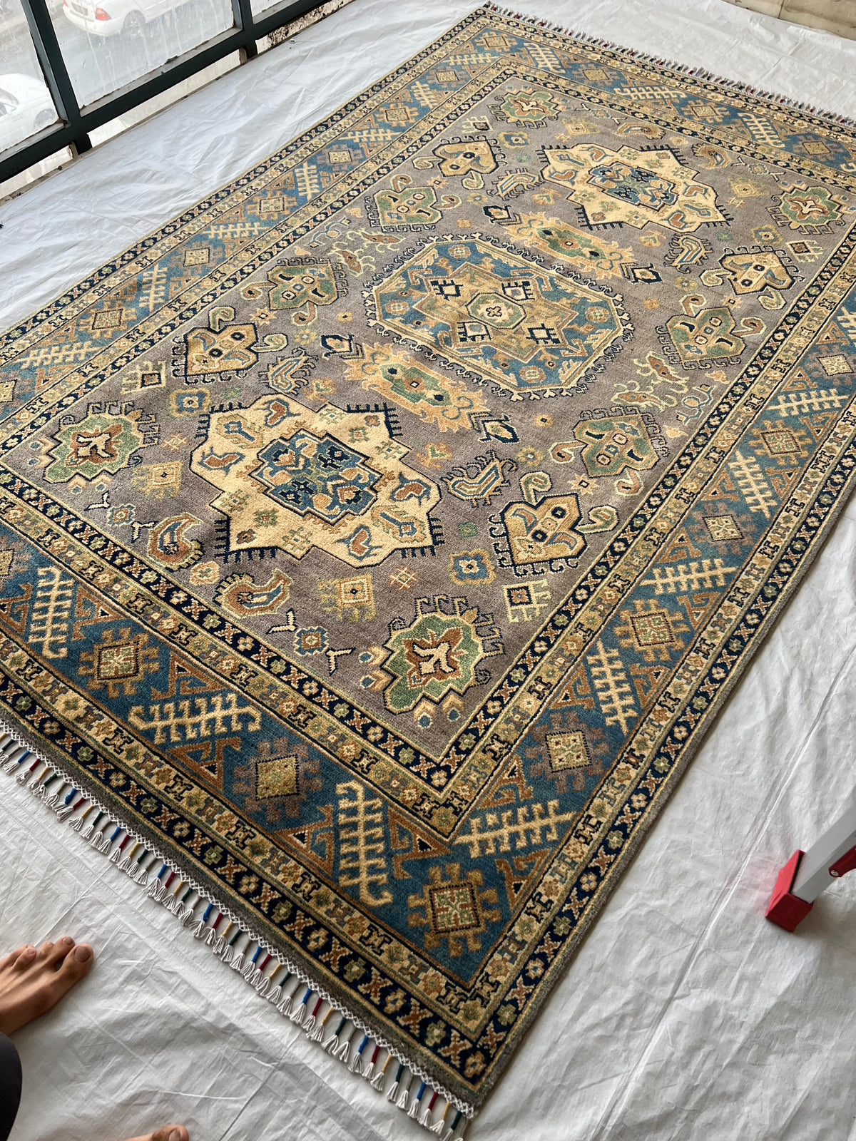 Kazak Rug 6x9 | Olive, Ivory & Navy | hand-knotted wool | angled view