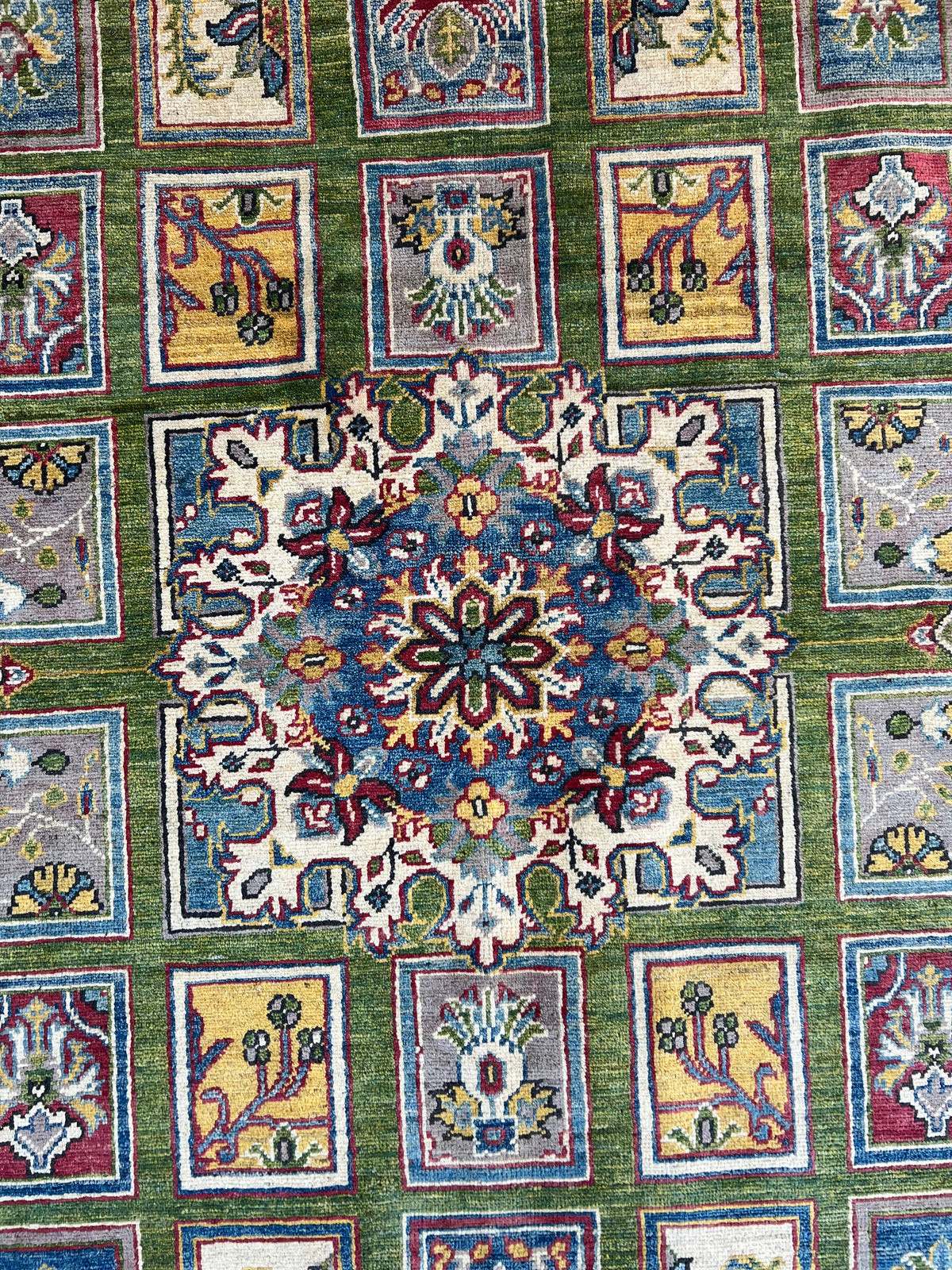 Kazak Garden Rug 8x10 | Green, Light Blue & Gold | hand-knotted wool | close-up of pile and border