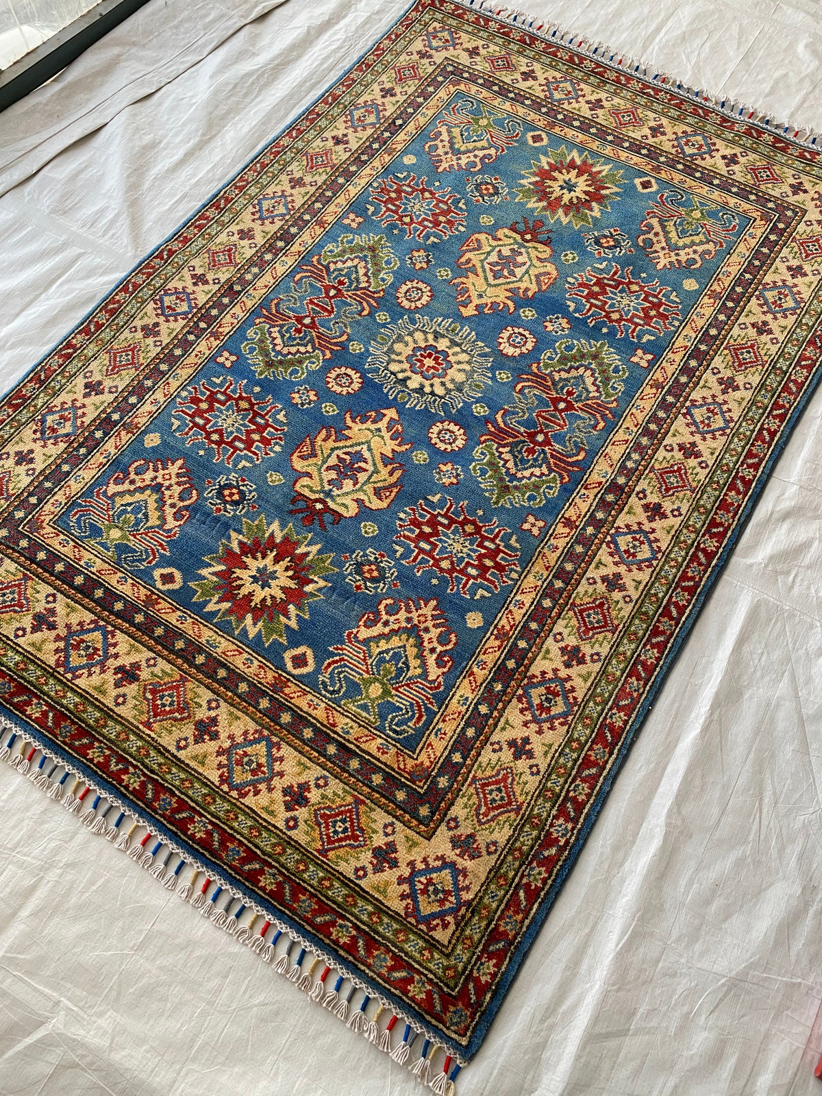 Kazak Rug 4x6 | Blue, Red & Ivory | hand-knotted wool | angled view