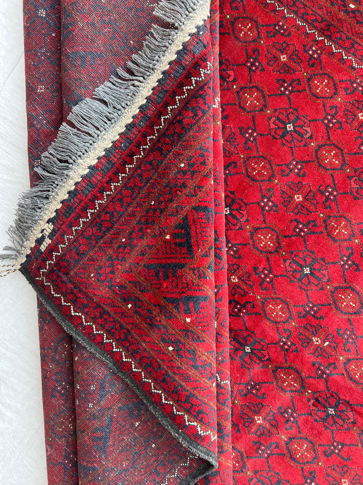 Bashiri Rug 6x9 | Red, Burgundy & Navy | hand-knotted wool | back of rug, knot detail