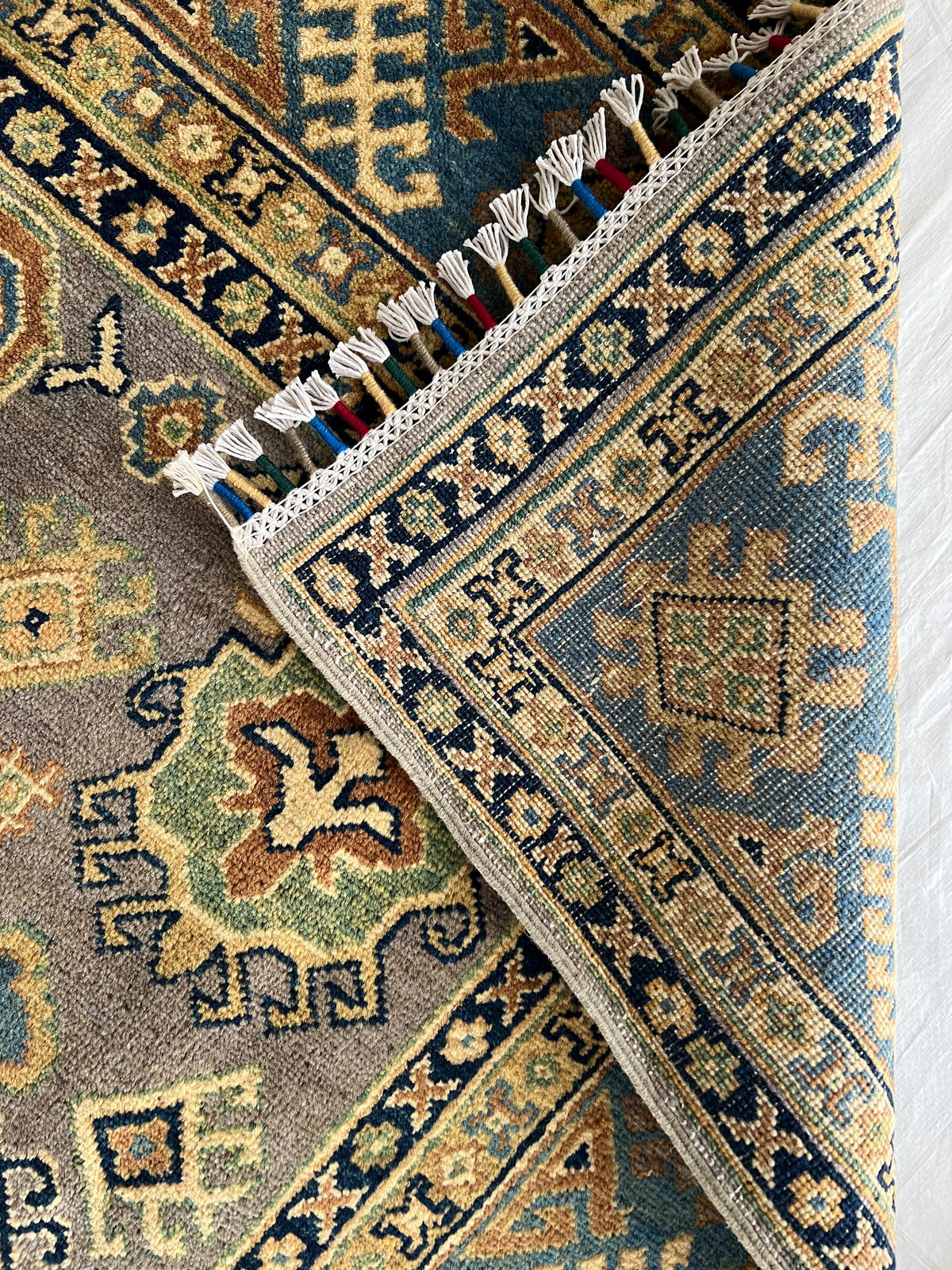 Kazak Rug 6x9 | Olive, Ivory & Navy | hand-knotted wool | back of rug, knot detail