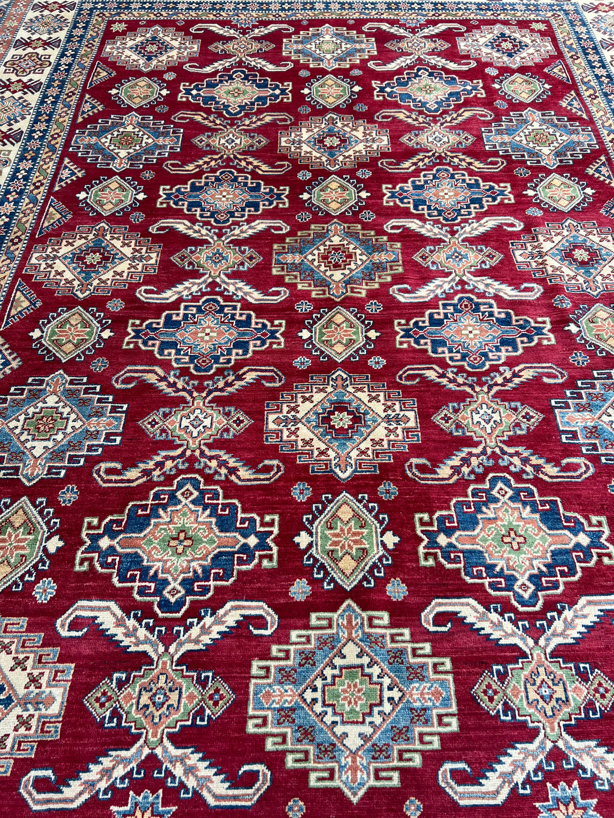Kazak Rug 9x12 | Red, Ivory & Blue | hand-knotted wool | close-up of pile and border