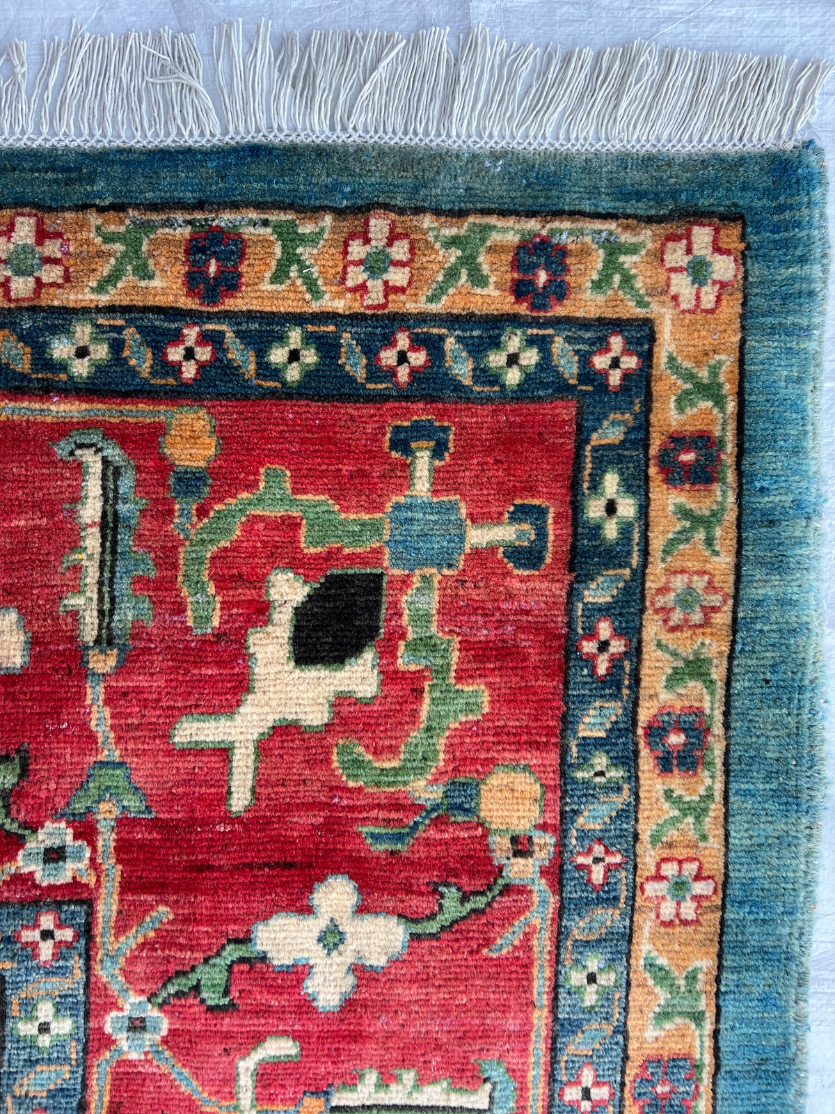 Kazak Rug 9x14 | Teal, Ivory & Red | hand-knotted wool | close-up of pile and border