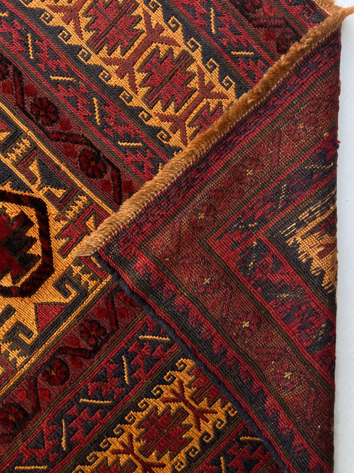 Baluch Rug 6x9 | Black, Gold & Burgundy | hand-knotted wool | back of rug, knot detail