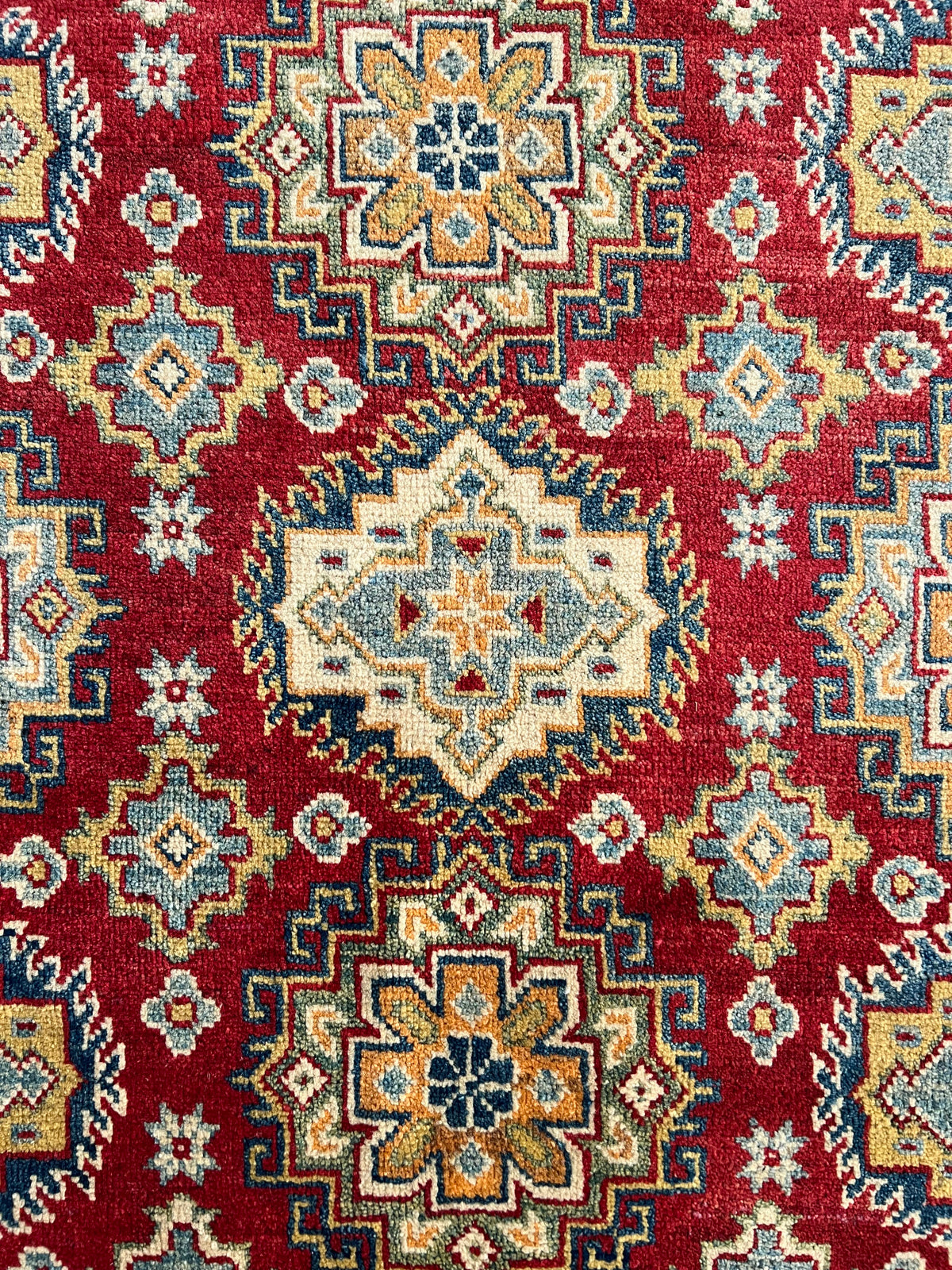 Kazak Rug 5x7 | Ivory, Red & Blue | hand-knotted wool | close-up of pile and border