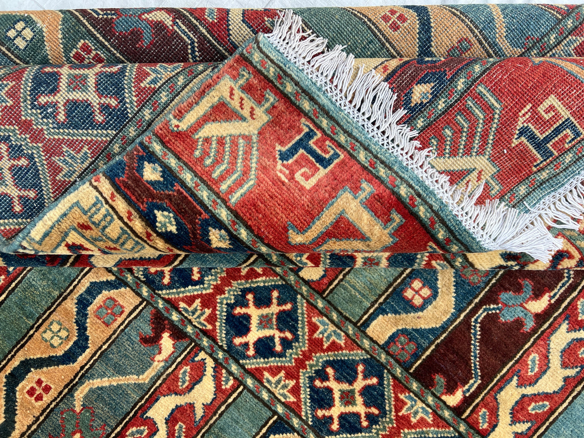 Kazak Rug 6x8 | Green, Red & Ivory | hand-knotted wool | close-up of pile and border