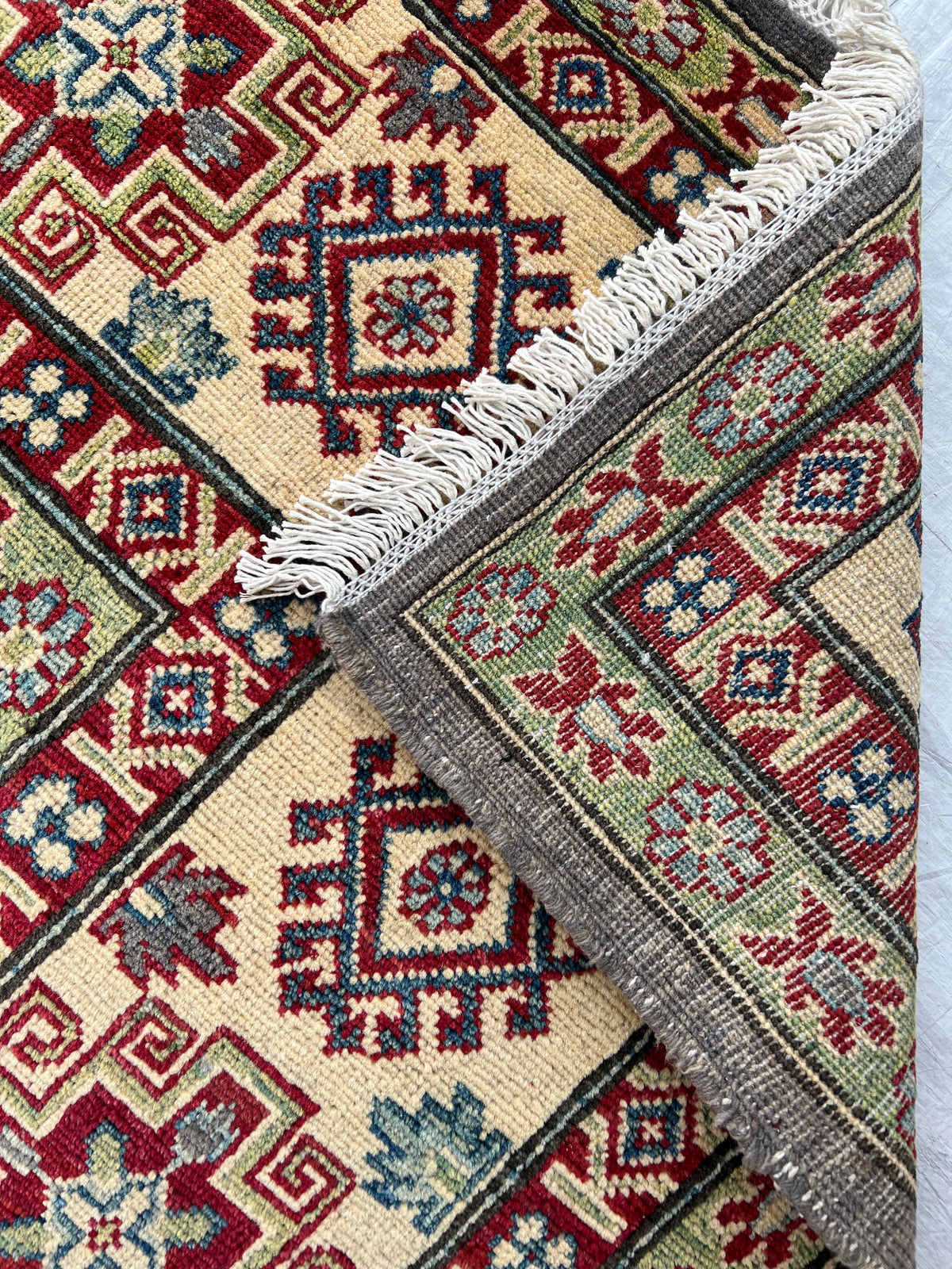 Kazak Rug 8x8 | Charcoal, Red & Ivory | hand-knotted wool | back of rug, knot detail