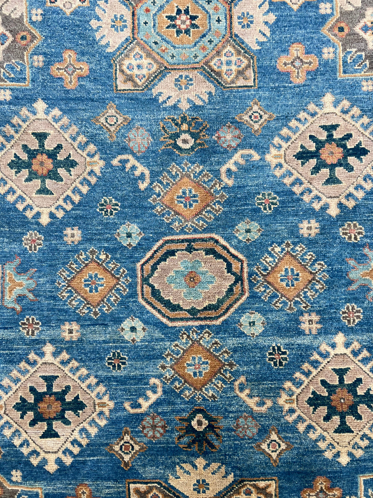 Kazak Rug 7x9 | Blue, Ivory & Gold | hand-knotted wool | close-up of pile and border