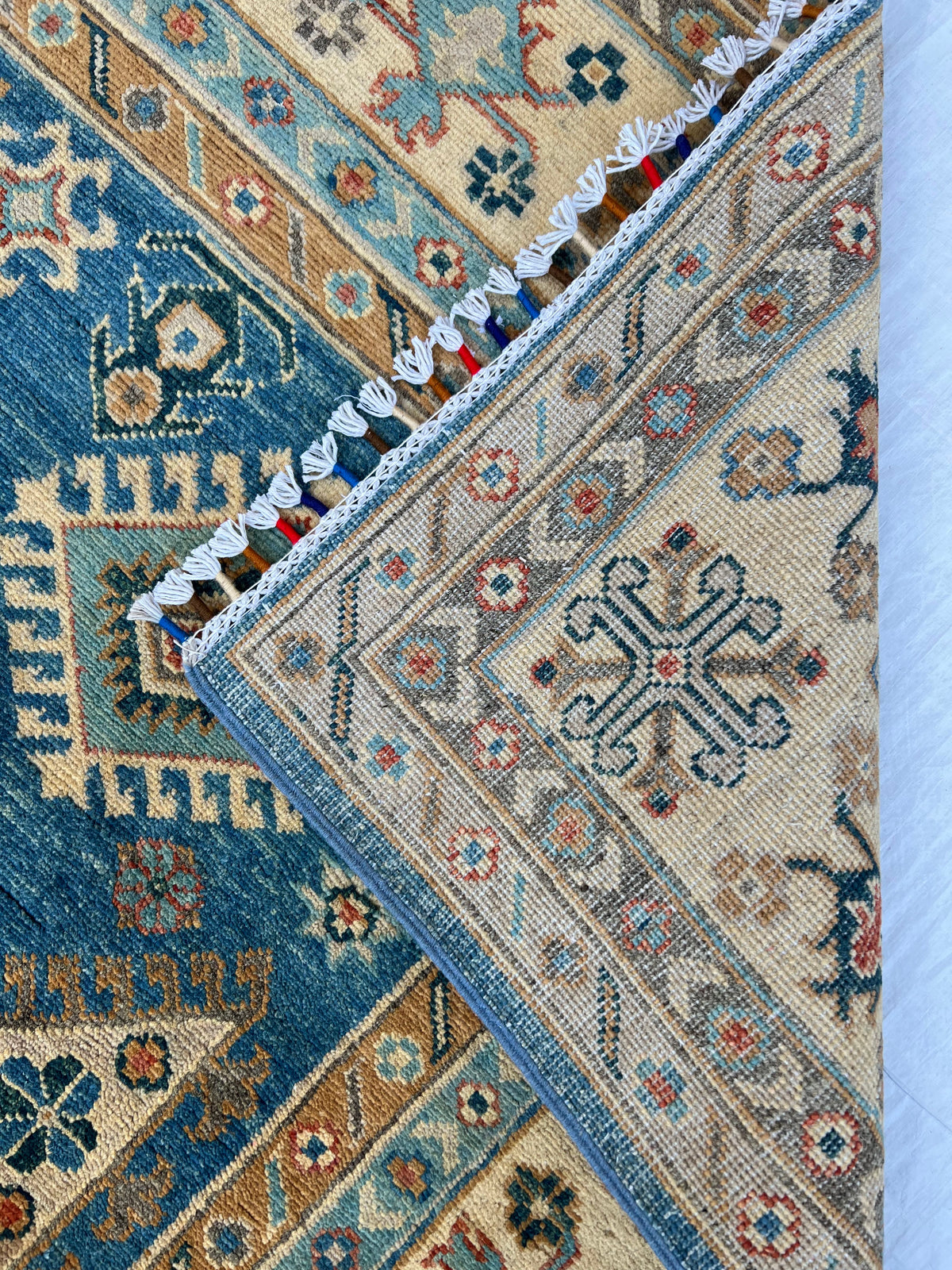 Kazak Rug 7x9 | Blue, Ivory & Gold | hand-knotted wool | back of rug, knot detail