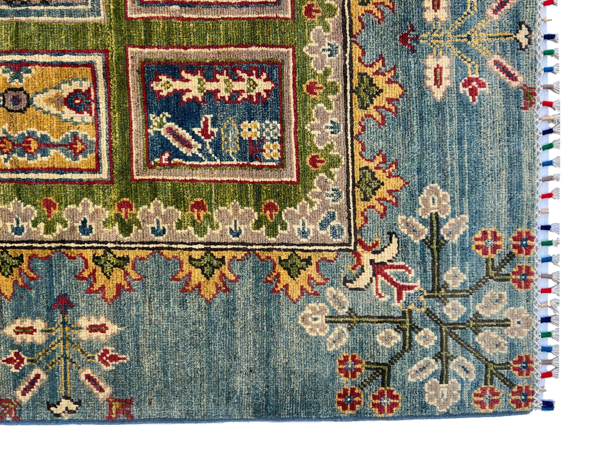 Kazak Garden Rug 8x10 | Green, Light Blue & Gold | hand-knotted wool | corner close-up